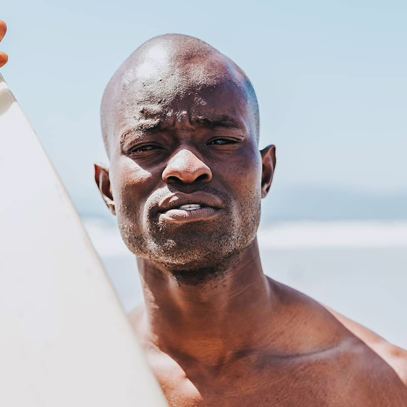 Man Holding Surfboard